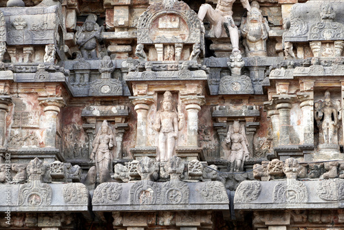 Ancient Hindu temple tower with stone carvings of God sculpture. Tall tower with idols at Airavatesvara Temple, Darasuram, Kumbakonam, Tamilnadu.