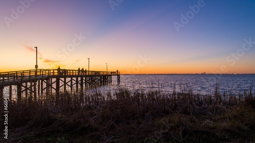 Pier at sunset on Mobile bay © George