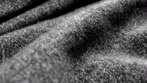 Macro dolly shot of DARK GRAY COTTON fabric with soft waves. Detailed texture and natural weave pattern visible.