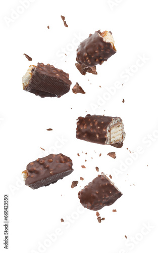 Pieces of chocolate bars falling on white background