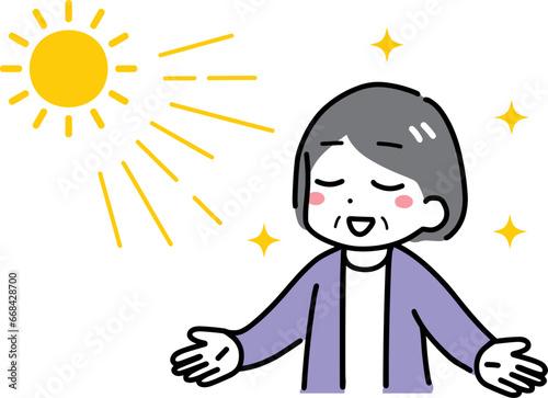 日光浴をしているシニアの女性