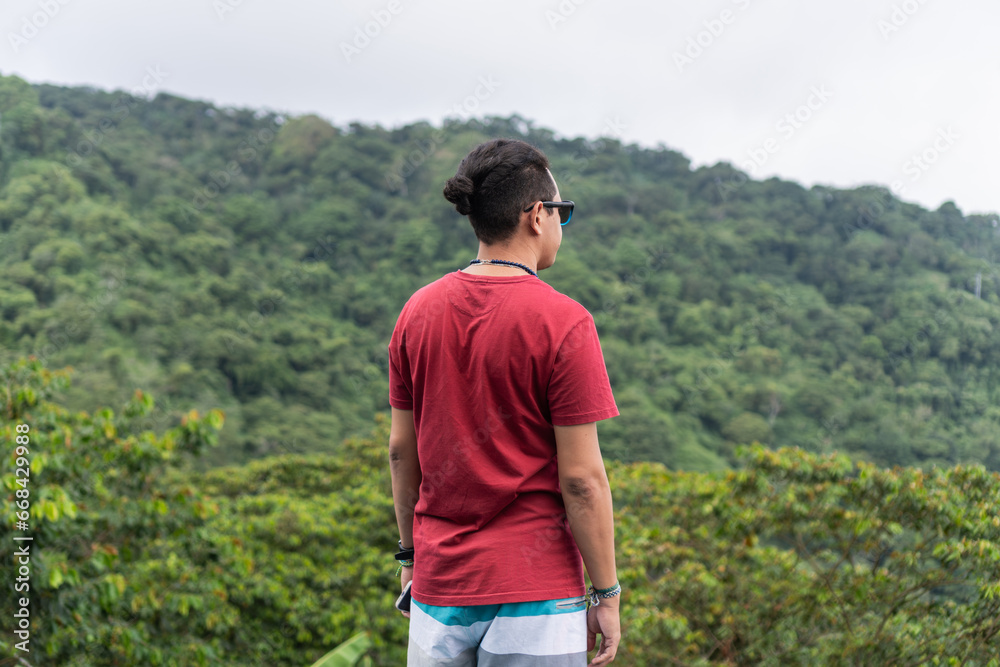 Latin Man on his back with the mountain in the background Latin Man on his back with the mountain in the background