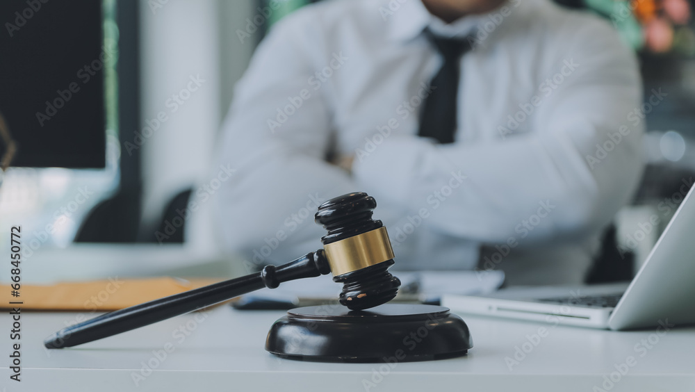 Judge gavel with Justice lawyers having team meeting at law firm in background. Concepts of law. Judge gavel with Justice lawyers having team meeting at law firm in background. Concepts of law.