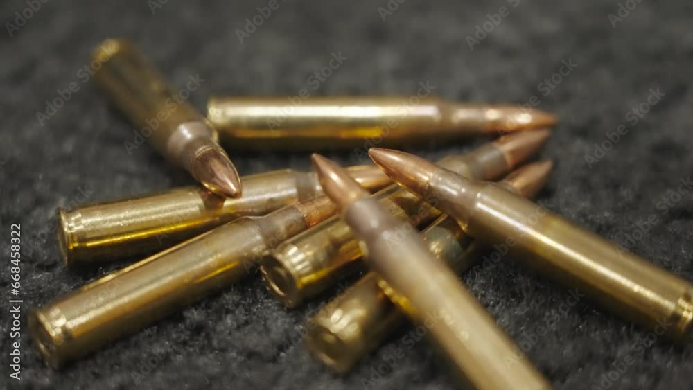 Close up in-camera motion showing the .30.30 rounds on a black rug. Close up in-camera motion showing the .30.30 rounds on a black rug.