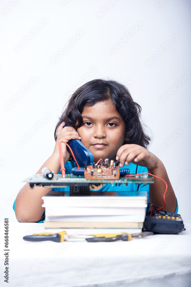 Student Girl holding a landline phone and voltmeter to studying electronic telecommunication Student Girl holding a landline phone and voltmeter to studying electronic telecommunication