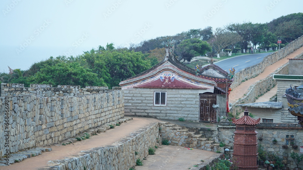 The Chinese old fisher village guarded by the stone built fortress wall The Chinese old fisher village guarded by the stone built fortress wall