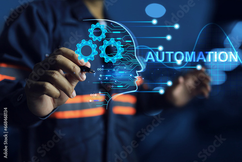 Robot automation concept engineer using automatic machine to work on industrial or factory system and writing to command programing to control machine operation photo