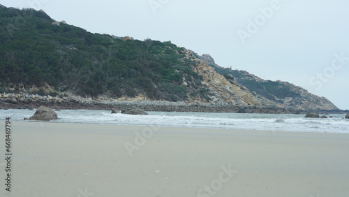 The ocean beach view with the rock shore and tide waves © Bo
