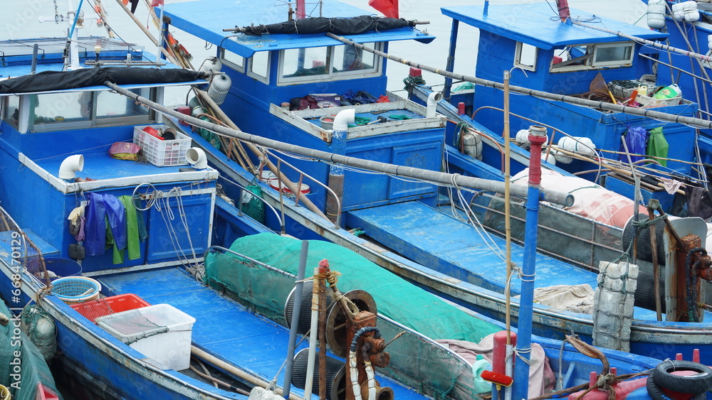 The peaceful sea view with the fishing boat sailing on it in the cloudy day The peaceful sea view with the fishing boat sailing on it in the cloudy day