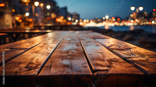 Empty wooden table top outdoors with bokeh light at night