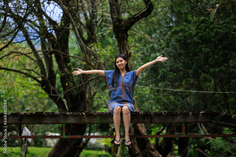 female holding hands and happy smiling on wooden bridge in the nature,
