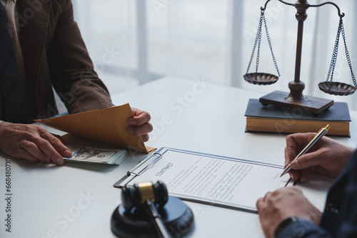 Government tax officials, legal advisers taking bribes of citizens wrapped in brown envelopes. Opening the annual tax evasion, the concept of bribing tax evader officials.
