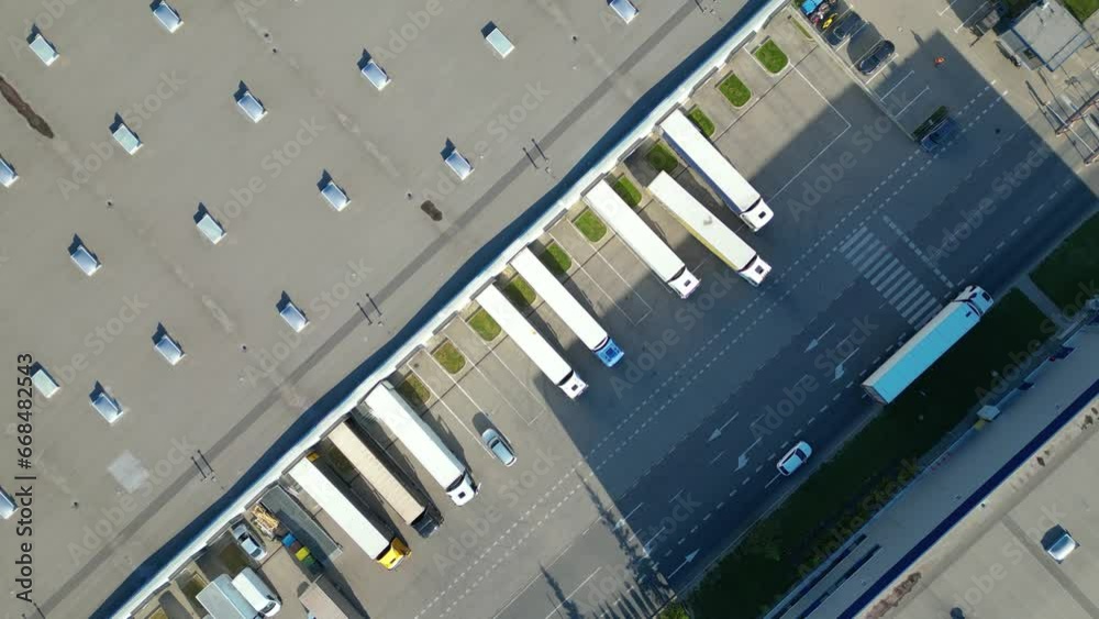Logistics park with warehouse. Semi-trailers trucks standing on car parking and waiting for loading and unloading goods at ramps. Aerial view Logistics park with warehouse. Semi-trailers trucks standing on car parking and waiting for loading and unloading goods at ramps. Aerial view