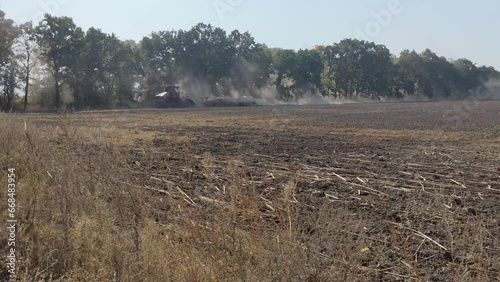 Chigirin, Ukraine - October 25, 2023 - Farmer plows the land in a field in the countryside. Autumn tillage. photo