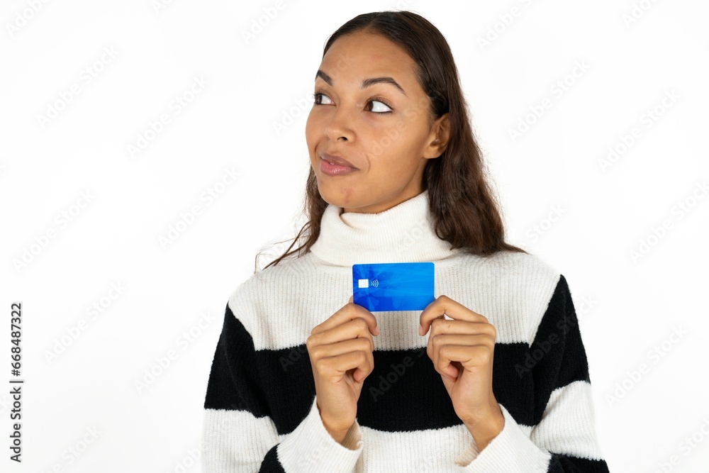 Photo of cheerful Young woman hold debit card look empty space Photo of cheerful Young woman hold debit card look empty space