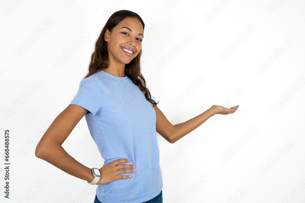 Young beautiful woman feeling happy and cheerful, smiling and welcoming you, inviting you in with a friendly gesture Young beautiful woman feeling happy and cheerful, smiling and welcoming you, inviting you in with a friendly gesture