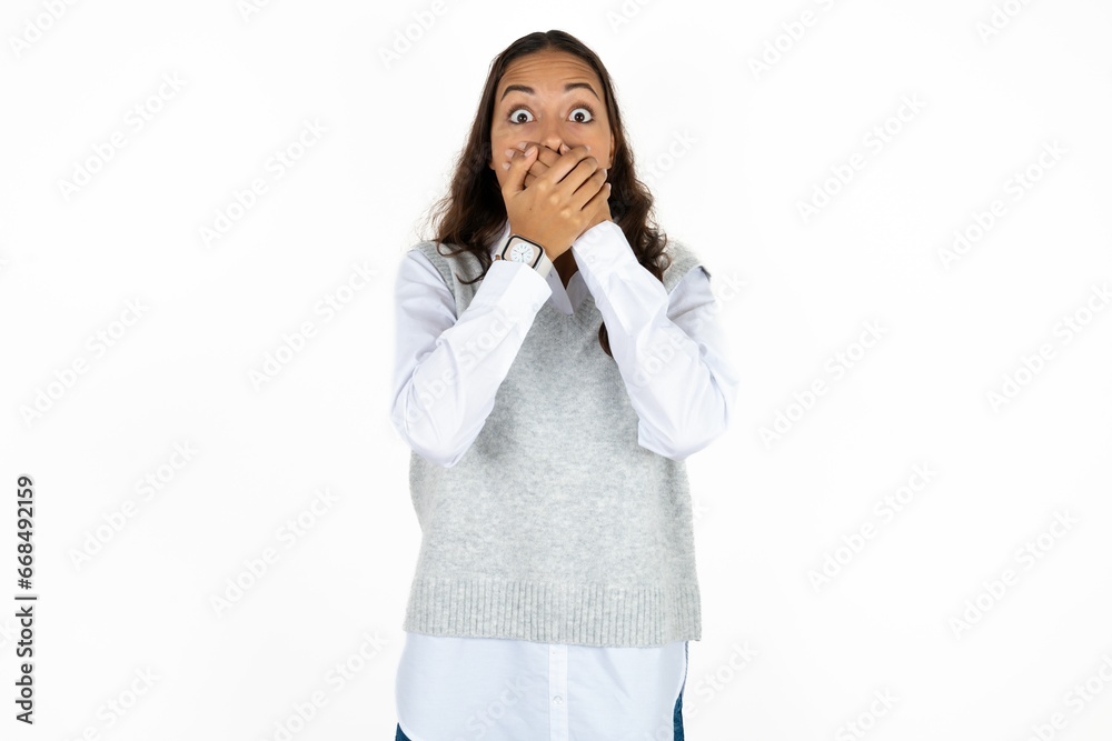 Stunned Young beautiful woman covers both hands on mouth, afraids of something astonishing Stunned Young beautiful woman covers both hands on mouth, afraids of something astonishing