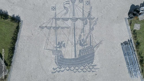 aerial view Zooming in on a caravel drawn on the Portuguese cobblestone pavement in the center of Lisbon.