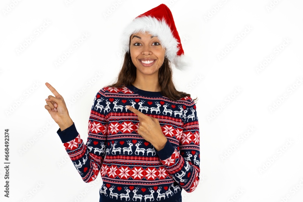 Beautiful woman wearing christmas sweater points at copy space indicates for advertising gives right direction Beautiful woman wearing christmas sweater points at copy space indicates for advertising gives right direction