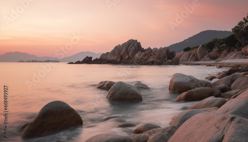 Tranquil scene sunset over rocky coastline, reflecting in calm waters generated by AI