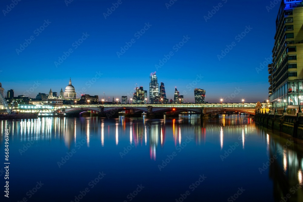 Beautiful view of London, England from the banks of the River Thames during the blue hour