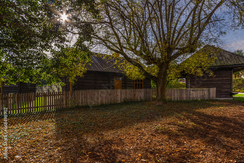 Three wooden country cottages in the town of Niepolomice, Poland. photo