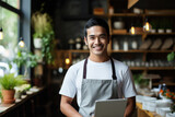 Man wearing apron holds laptop, ready to work. This image is perfect for showcasing technology in professional or home setting.