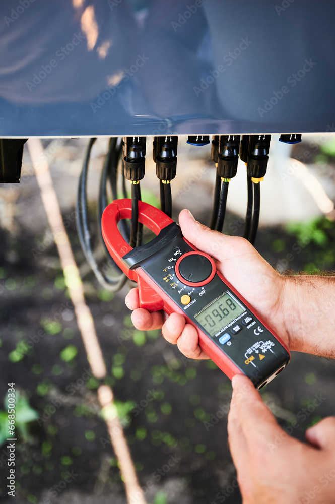 Checking of output voltage level of inverter. Professional worker using