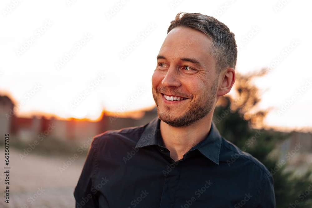 Portrait of handsome successful man standing outdoors Portrait of handsome successful man standing outdoors