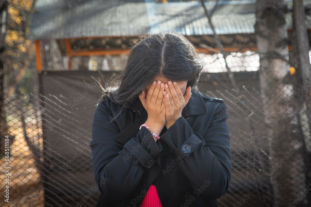 Caucasian young girl covering her face. Caucasian young girl covering her face.