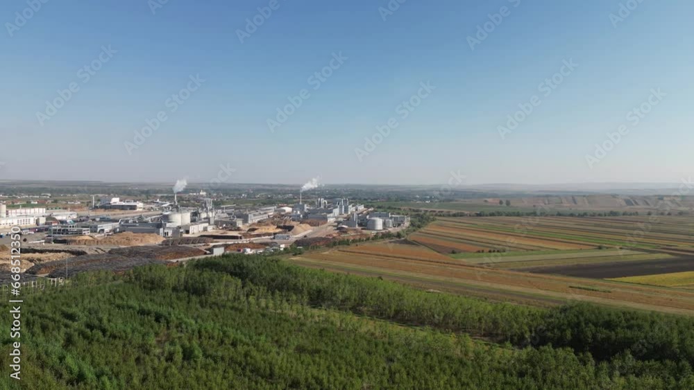 Timelapse view of countryside green fields and industrial factors area with smoke on the horizon Timelapse view of countryside green fields and industrial factors area with smoke on the horizon