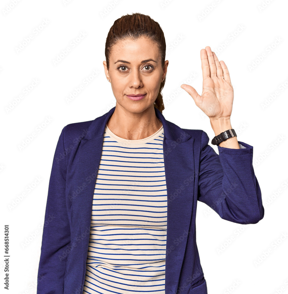 Middle-aged female entrepreneur in studio standing with outstretched hand showing stop sign, preventing you. Middle-aged female entrepreneur in studio standing with outstretched hand showing stop sign, preventing you.