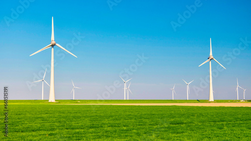 Windmill turbines at sea seen from a drone aerial view from above at a huge windmill park