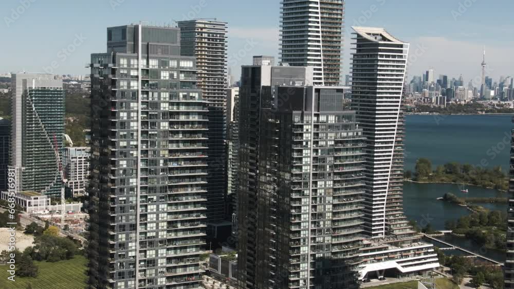 Glass and concrete skyscrapers of Lake Ontario are shining above the ground on a sunny day Glass and concrete skyscrapers of Lake Ontario are shining above the ground on a sunny day