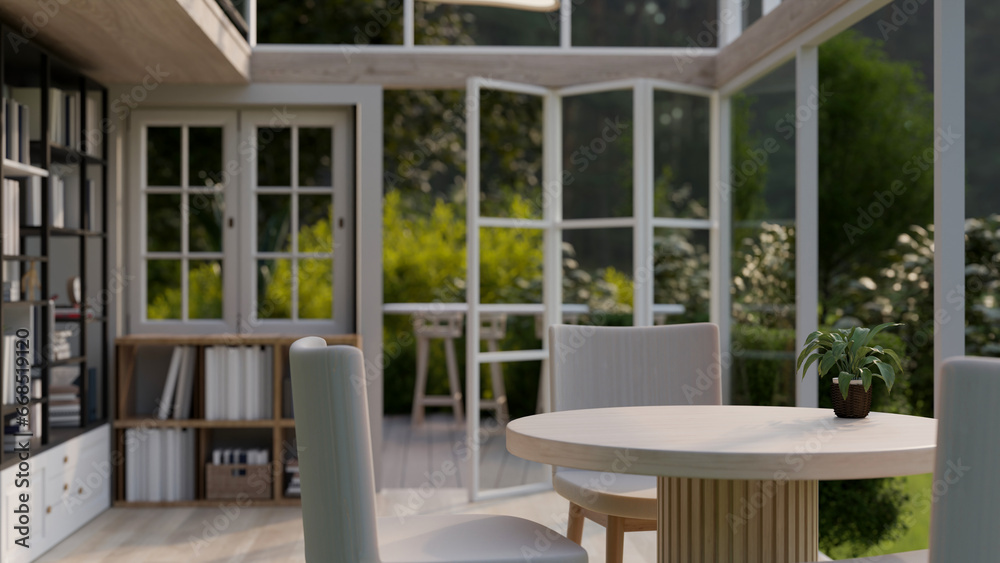 Copy space on a minimal dining table in a cosy room with a way through a beautiful garden on a deck.