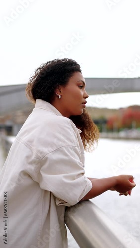 Sad African American woman thinking outdoors, beside the river
