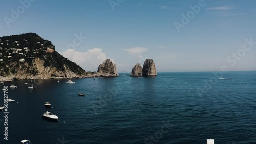 Aerial of Capri, Italy's beautiful sea water filled with boats. photo