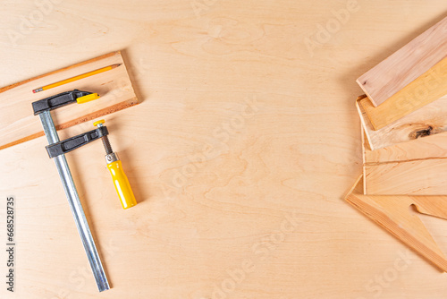 Craftsmanship and Carpentry Concepts. Two Batch Parts of Professional Assorted Work Tools With Wooden Materials in Workshop.