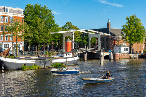 Amsterdam lift bridge canal river with boats photo