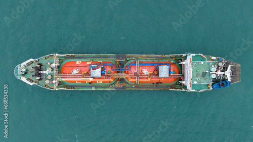 Cargo Container ship with contrail in the ocean ship carrying container and running for import export concept technology freight shipping by ship. © Yellow Boat