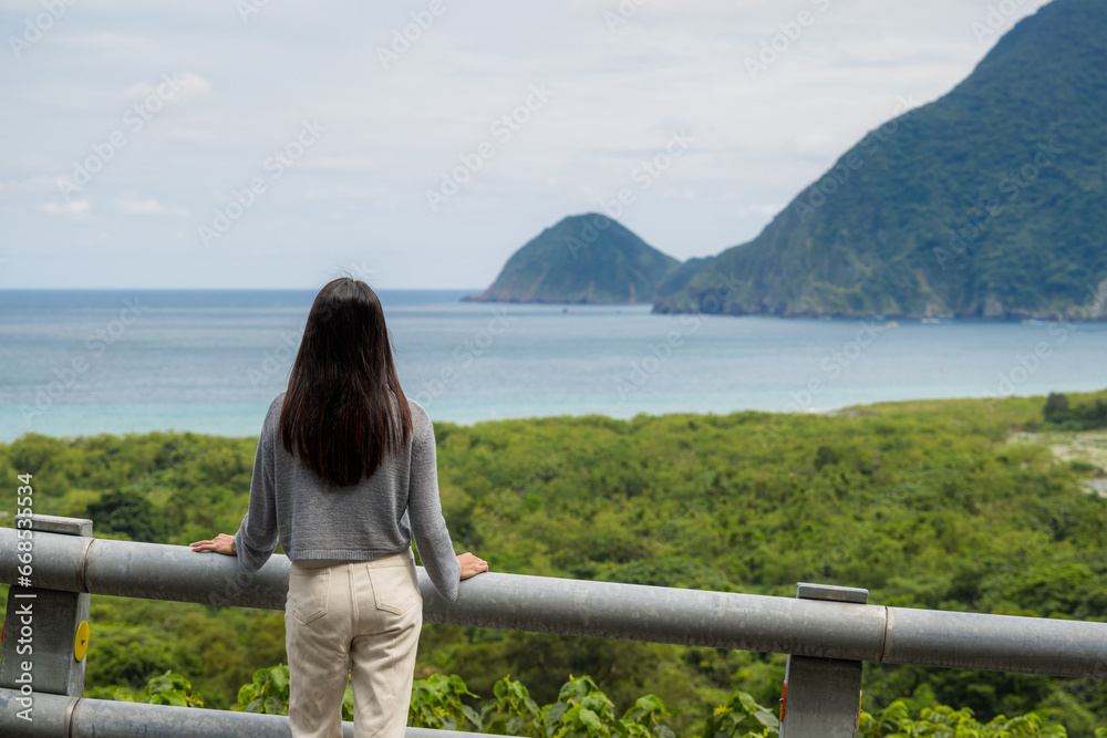 Woman look at the sea with mountain