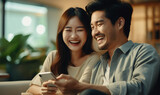 Couple asian people using smartphone and laughing. Happiness moment