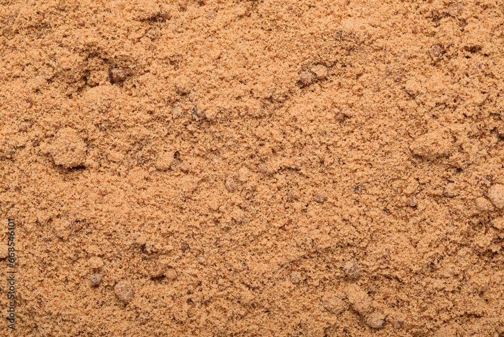 Background of brown sugar granules. Natural sweeteners are a healthy food choice.
