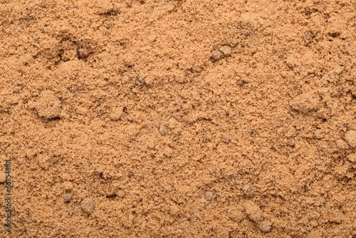 Background of brown sugar granules. Natural sweeteners are a healthy food choice.