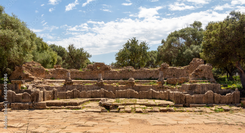 Ruins of the Roman Archeological Park of Tipaza, Tipasa, Algeria : theater. Beautiful green trees and blue sky.