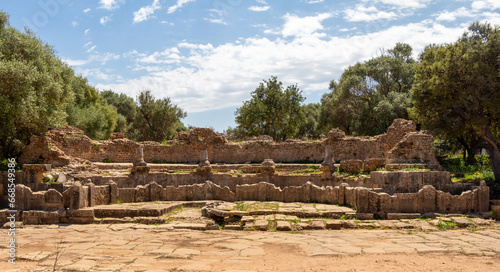 Ruins of the Roman Archeological Park of Tipaza, Tipasa, Algeria : theater. Beautiful green trees and blue sky.