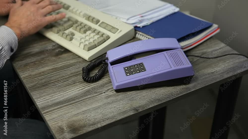 A nervous man in the office breaks his phone and throws it off the table. The man doesn't want to talk on the phone. A man works at a computer on the keyboard. Video with sound. A nervous man in the office breaks his phone and throws it off the table. The man doesn't want to talk on the phone. A man works at a computer on the keyboard. Video with sound.