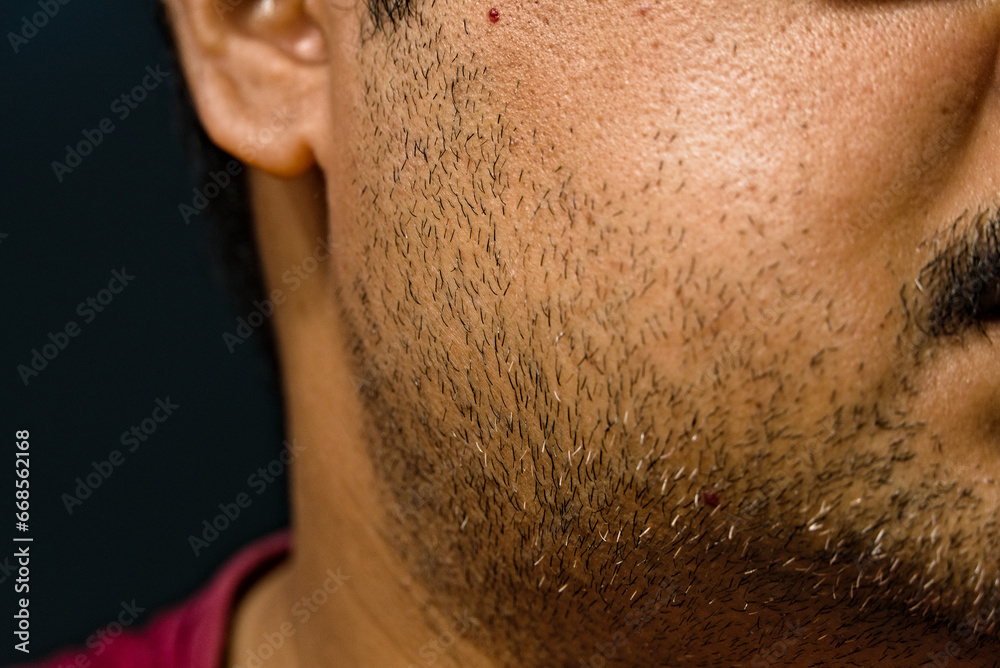 partially blurred side view of face of Indian adult male