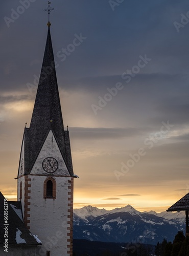 Winter sunset landscape of an old austrian church in an alps village  snowy mountains  Wallfahrtskirche Maria Schnee Matzelsdorf