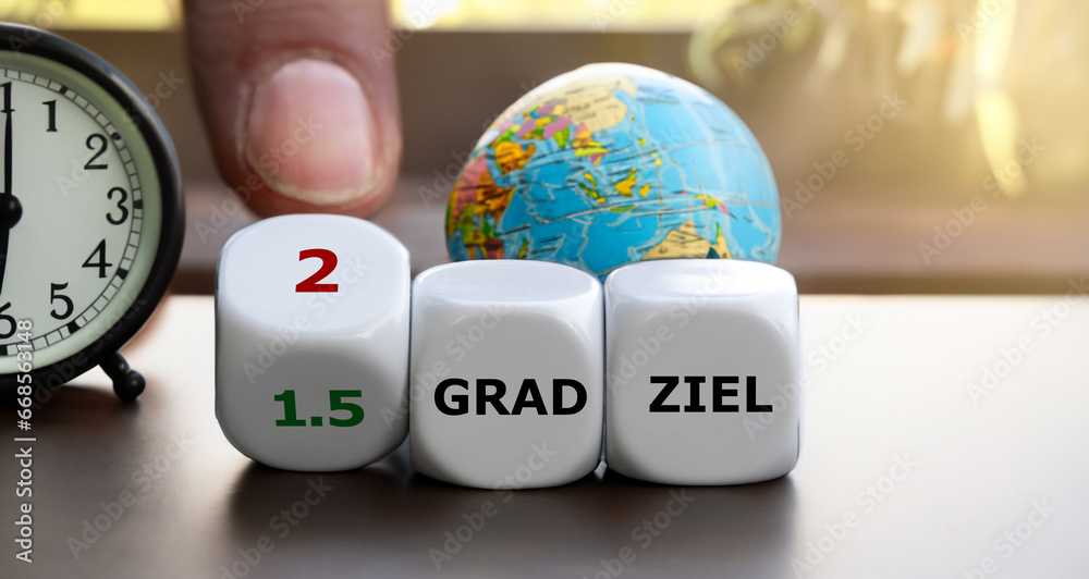 Hand turns dice and changes the expression '1.5 grad ziel' (1.5 degree target) to '2 grad ziel' (2degree target). - obrazy, fototapety, plakaty 